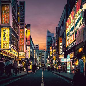 Explore the vibrant nightlife of Shibuya, Tokyo, showcasing neon-lit streets bustling with activity after sunset.