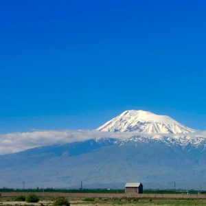 A scenic view of snow-capped Mount Ararat in Armenia with a clear blue sky.